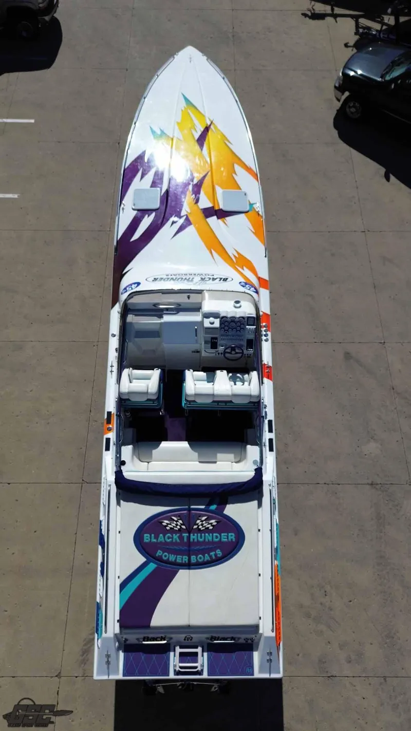 Slide: The Image of Aerial view of 2001 Black Thunder 43 GT Flat Deck powerboat with colorful graphics. - 22