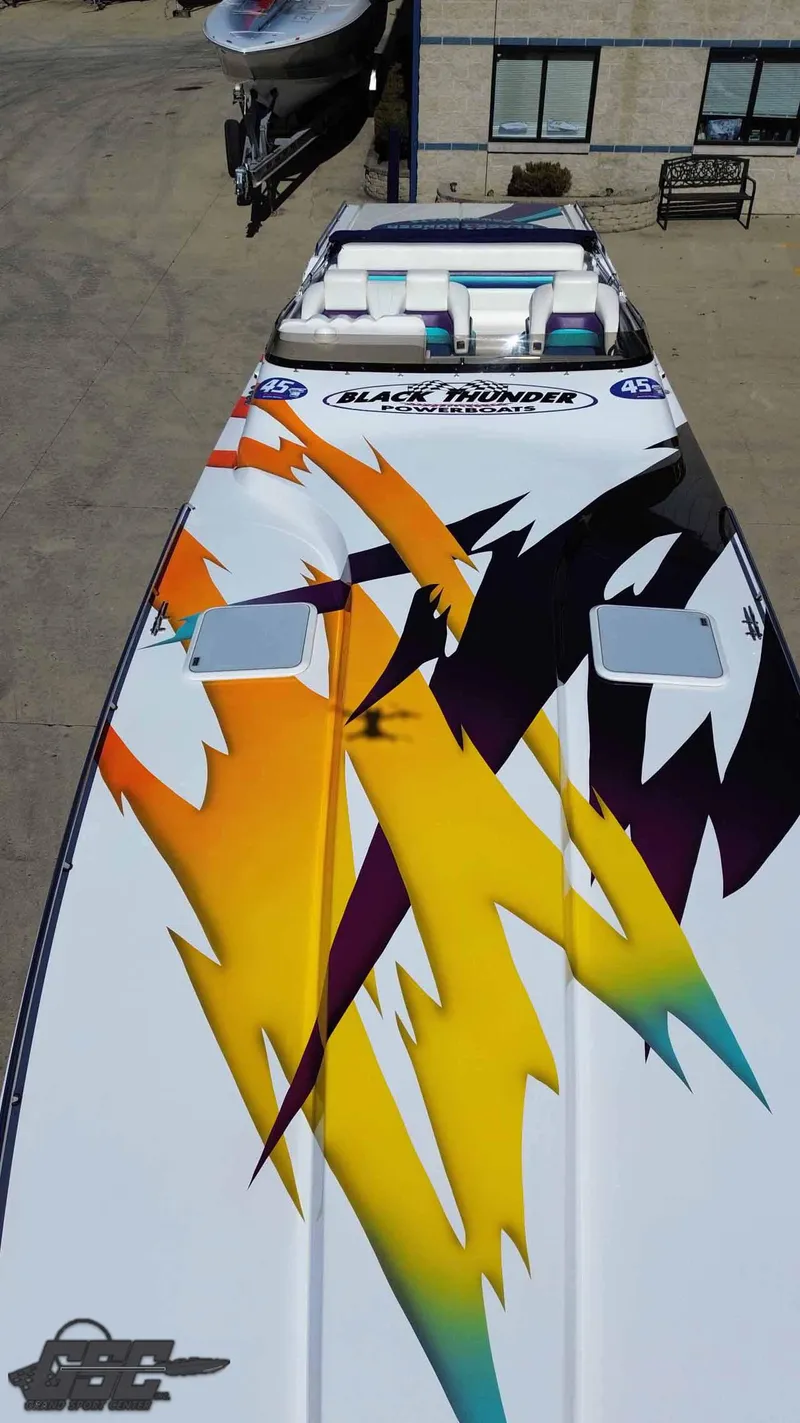 Slide: The Image of 2001 Black Thunder 43 GT Flat Deck boat with vibrant abstract graphics. - 27