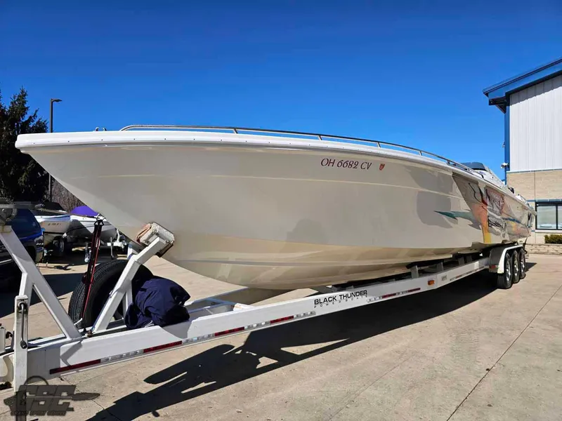 Slide: The Image of 2001 Black Thunder 43 GT Flat Deck boat on trailer, parked outdoors. - 29