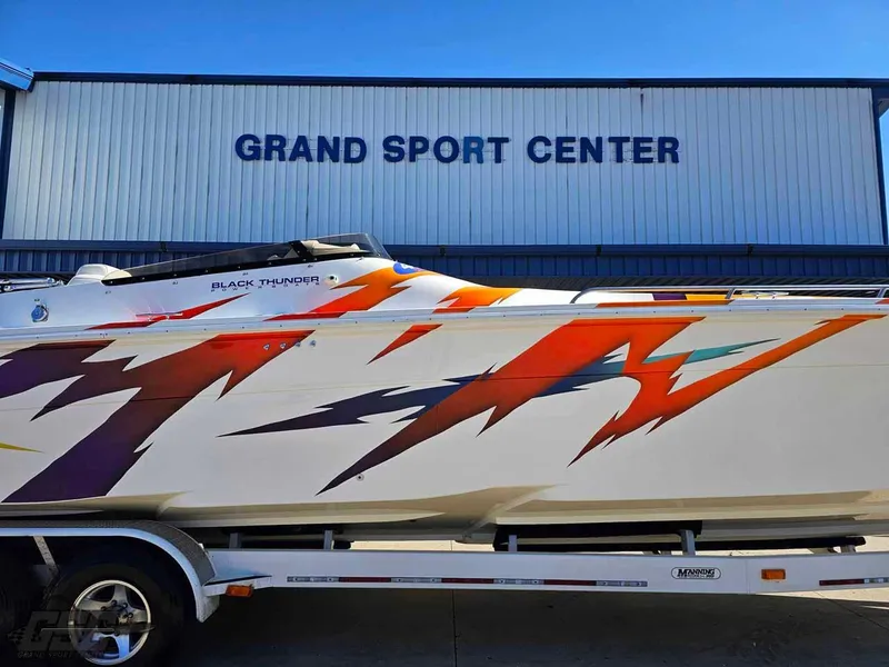 Slide: The Image of 2001 Black Thunder 43 GT Flat Deck boat with vibrant graphics at Grand Sport Center. - 3