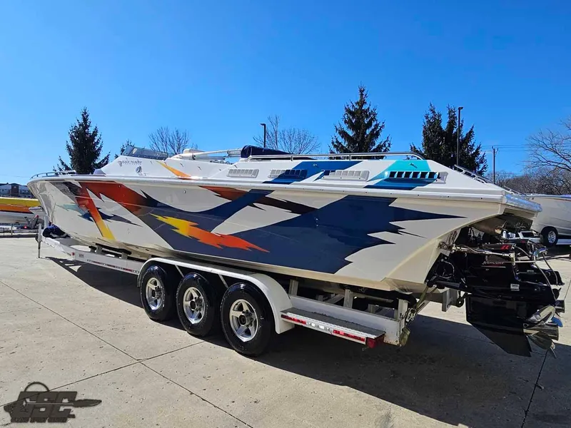 Slide: The Image of 2001 Black Thunder 43 GT Flat Deck boat with vibrant graphics on a trailer. - 41