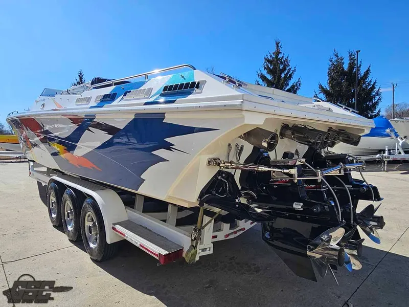 Slide: The Image of 2001 Black Thunder 43 GT Flat Deck boat on a trailer, showcasing sleek design and powerful engines. - 42