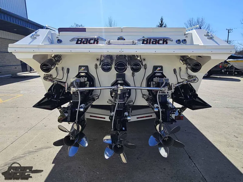 Slide: The Image of Rear view of a 2001 Black Thunder 43 GT Flat Deck boat with powerful engines. - 43