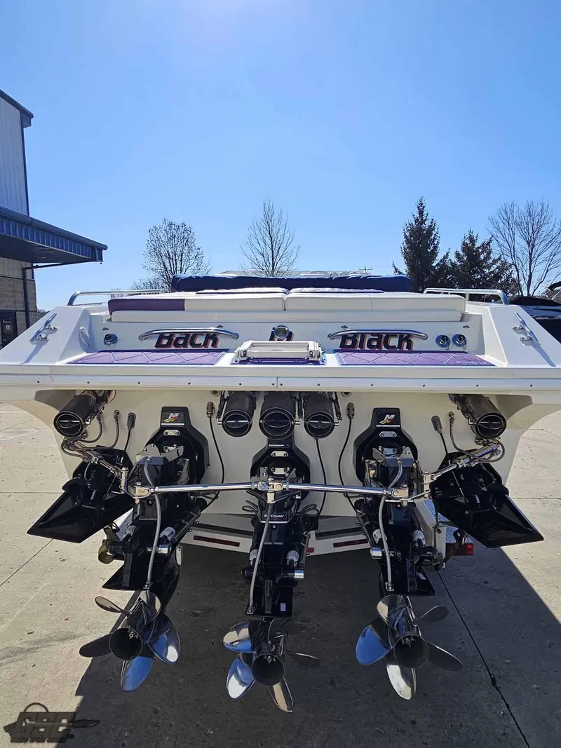 Slide: The Image of 2001 Black Thunder 43 GT Flat Deck boat with powerful engines, docked outdoors. - 44