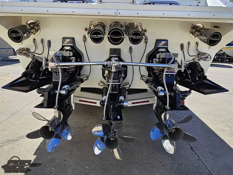 Slide: The Image of Rear view of 2001 Black Thunder 43 GT Flat Deck with triple outboard motors. - 46