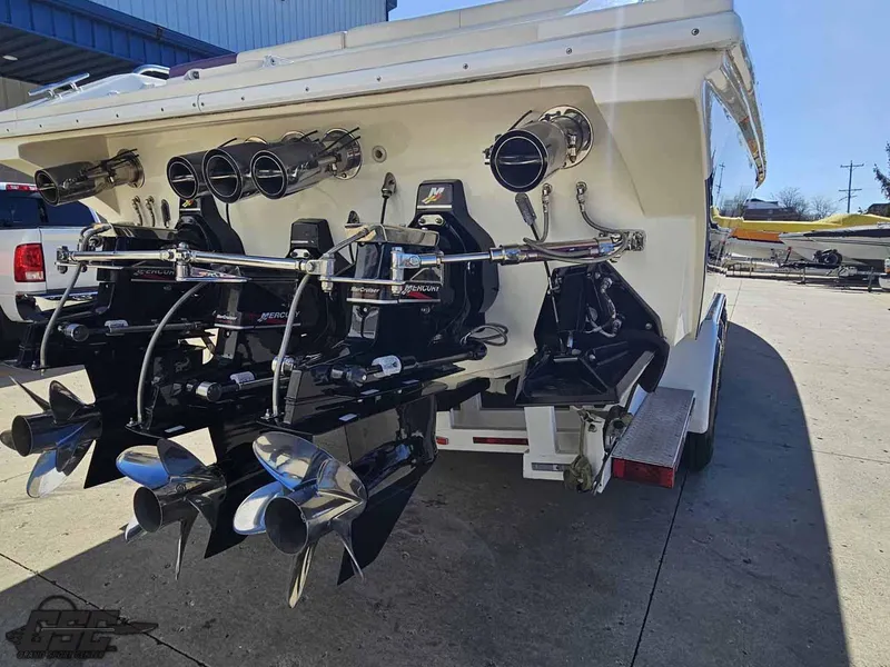 Slide: The Image of Rear view of a 2001 Black Thunder 43 GT Flat Deck boat with powerful engines. - 47