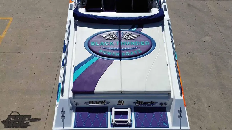 Slide: The Image of 2001 Black Thunder 43 GT Flat Deck powerboat with custom graphics on deck. - 49