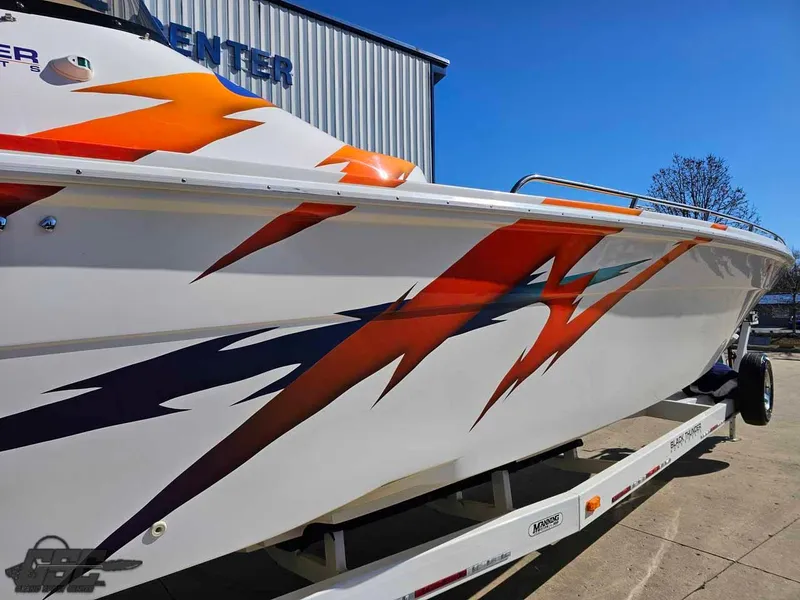 Slide: The Image of 2001 Black Thunder 43 GT Flat Deck boat with vibrant orange and blue graphics. - 7