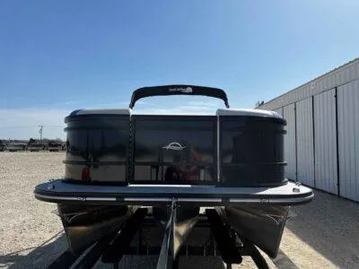Slide: The Image of 2025 SunCatcher Select 322SS pontoon boat, sleek design, parked outdoors. - 2