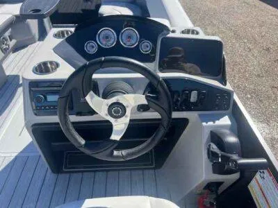 Slide: The Image of 2025 SunCatcher Select 322SS boat dashboard with steering wheel and control panel. - 8