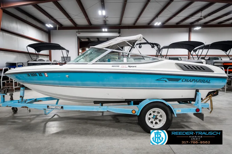 Slide: The Image of 1991 Chaparral 1800 SL boat on trailer in indoor showroom. - 10
