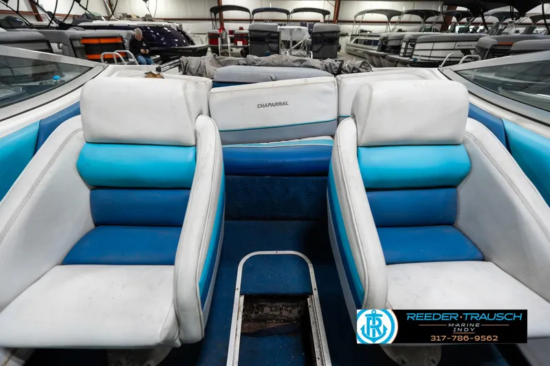 Slide: The Image of 1991 Chaparral 1800 SL boat interior with blue and white seating. - 16