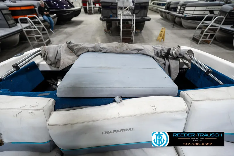 Slide: The Image of 1991 Chaparral 1800 SL boat interior with white seating in a showroom. - 17