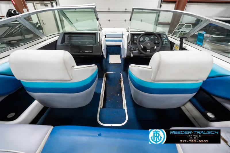Slide: The Image of 1991 Chaparral 1800 SL boat interior with blue and white seating, dashboard, and steering wheel. - 18