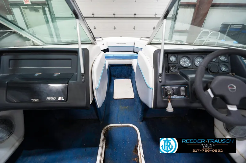 Slide: The Image of Interior view of a 1991 Chaparral 1800 SL boat with blue carpet and dashboard controls. - 19