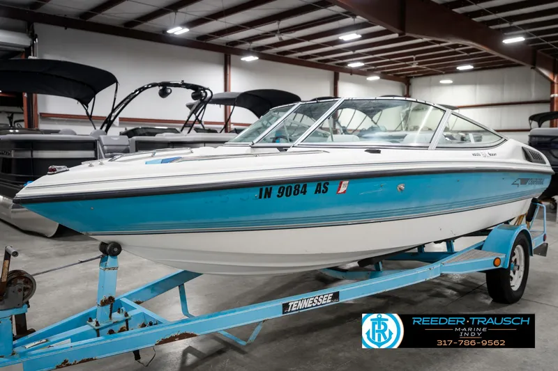 Slide: The Image of 1991 Chaparral 1800 SL boat on trailer in indoor showroom. - 2