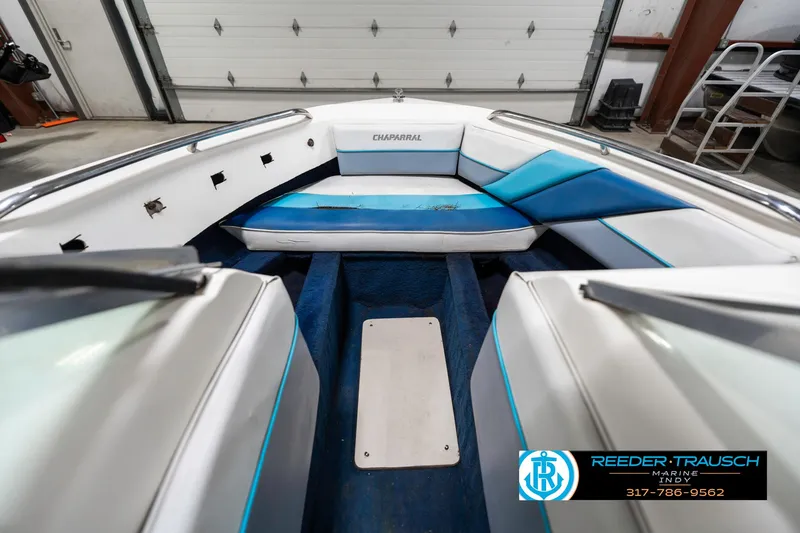 Slide: The Image of Interior of a 1991 Chaparral 1800 SL boat with blue and white seating. - 21