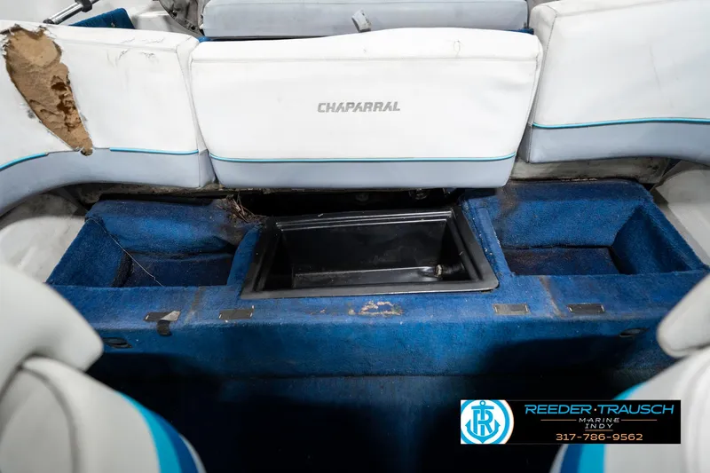 Slide: The Image of 1991 Chaparral 1800 SL boat interior with blue carpet and white seating. - 22