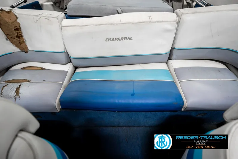 Slide: The Image of 1991 Chaparral 1800 SL boat interior with worn blue and white seating. - 23