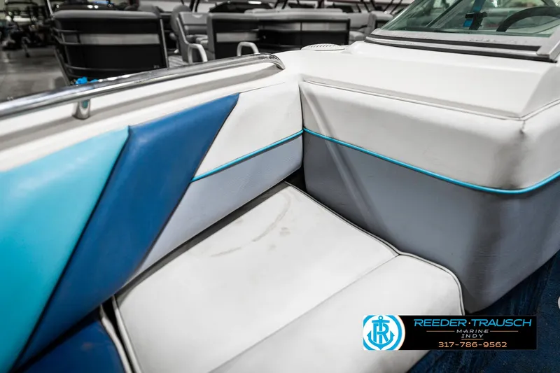 Slide: The Image of 1991 Chaparral 1800 SL boat interior with blue and white seating, Reeder-Trausch Marine logo visible. - 34