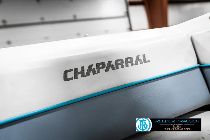 Slide: The Image of 1991 Chaparral 1800 SL boat with logo, featuring white and blue design. - 36