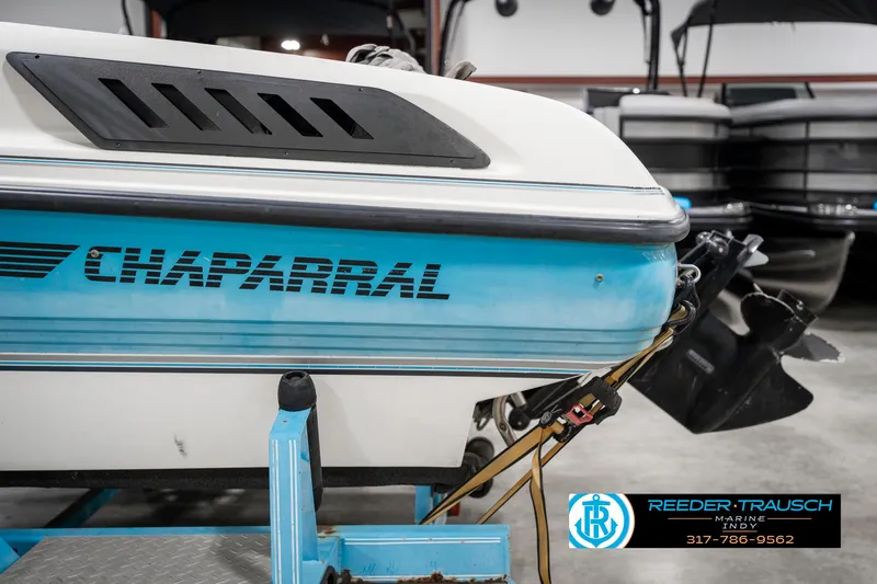 Slide: The Image of 1991 Chaparral 1800 SL boat on trailer in showroom, Reeder-Trausch Marine logo visible. - 42