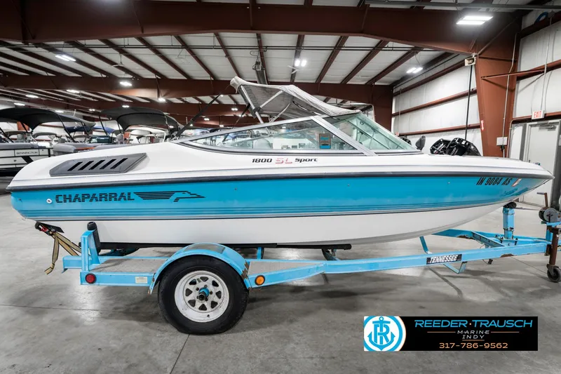 Slide: The Image of 1991 Chaparral 1800 SL boat on trailer in indoor showroom. - 6