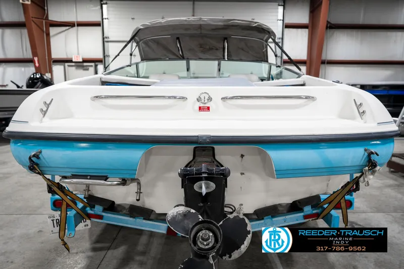 Slide: The Image of 1991 Chaparral 1800 SL boat in a warehouse, rear view with visible propeller. - 8