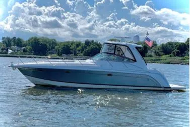 The Image of 2005 Formula 40pc boat cruising on a sunny day with scenic background. - 0