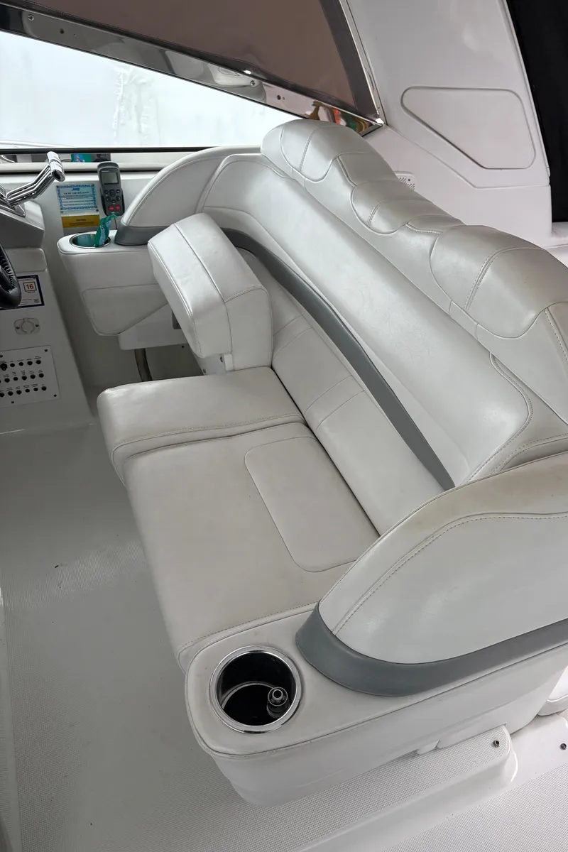 Slide: The Image of 2005 Formula 40pc boat interior with white leather seating and cup holder. - 10