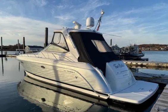 Slide: The Image of 2005 Formula 40pc yacht docked in a marina under a clear blue sky. - 2