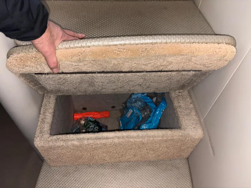 Slide: The Image of Hidden storage compartment in a 2005 Formula 40pc boat, containing miscellaneous items. - 28