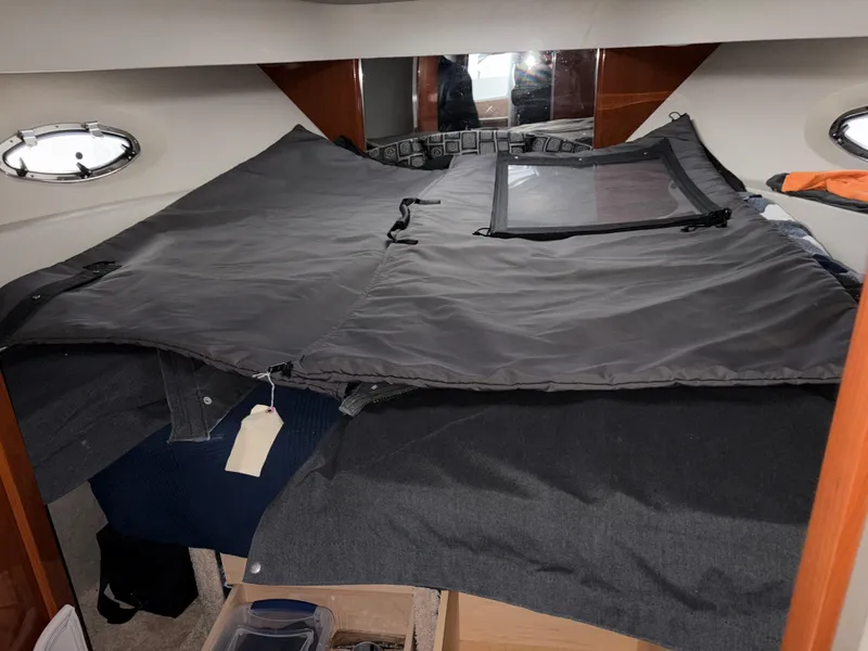 Slide: The Image of 2005 Formula 40pc boat interior with covered bed and portholes. - 30