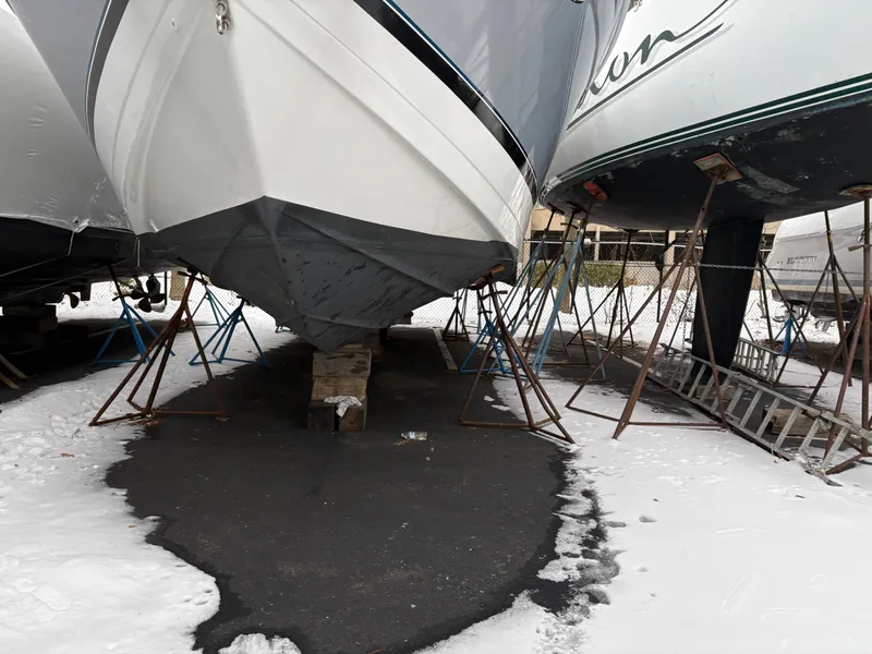 Slide: The Image of 2005 Formula 40pc boat in winter storage, supported by stands on a snowy surface. - 35