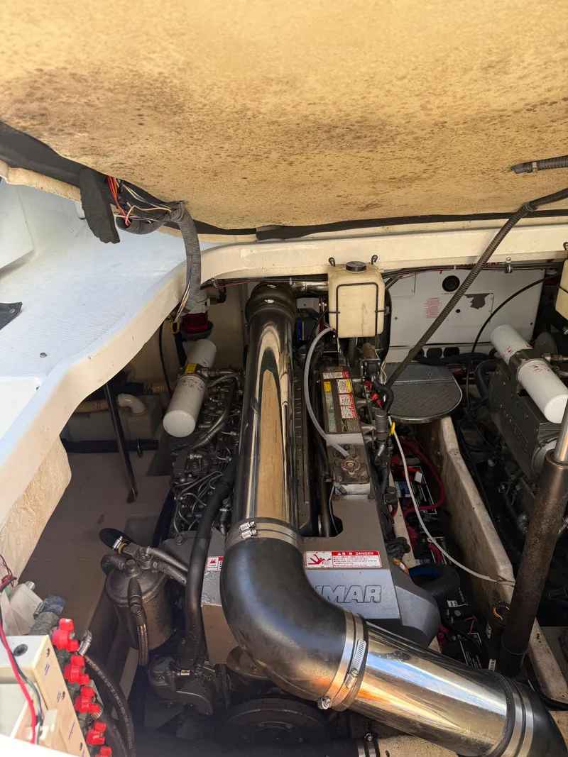 Slide: The Image of Engine compartment of a 2005 Formula 40pc boat, showcasing mechanical components and wiring. - 38