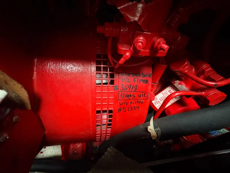 Slide: The Image of Red engine component with handwritten maintenance notes, Formula 40pc, 2005 model. - 42