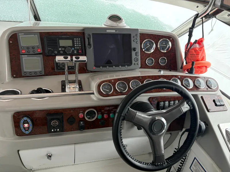 Slide: The Image of Control panel of a 2005 Formula 40pc boat with steering wheel and navigation instruments. - 6