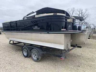 Slide: The Image of 2025 SunCatcher Select 322RC pontoon boat on trailer, parked outdoors. - 2