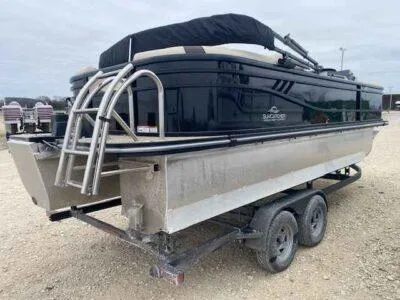 Slide: The Image of 2025 SunCatcher Select 322RC pontoon boat on trailer, rear view with ladder. - 3