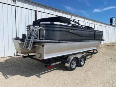 Slide: The Image of 2025 SunCatcher Select 322RC pontoon boat on trailer, parked outdoors. - 3