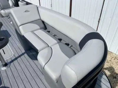 Slide: The Image of 2025 SunCatcher Select 322RC boat interior with gray cushioned seating. - 8