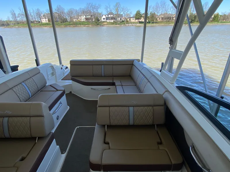 Slide: The Image of 2016 Sea Ray 270 Sundeck interior with spacious seating, overlooking a serene lake. - 5