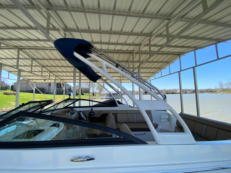 Slide: The Image of 2016 Sea Ray 270 Sundeck boat docked under a covered marina. - 7