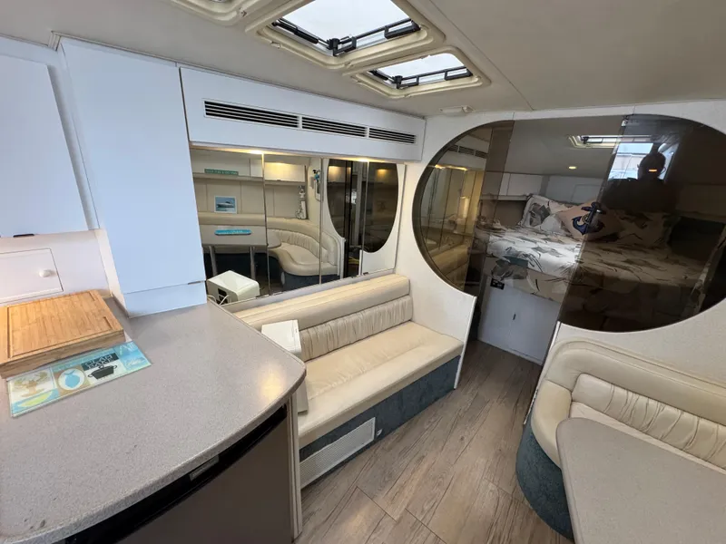Slide: The Image of 1995 Silverton Express yacht interior with modern seating, wood flooring, and skylights. - 14