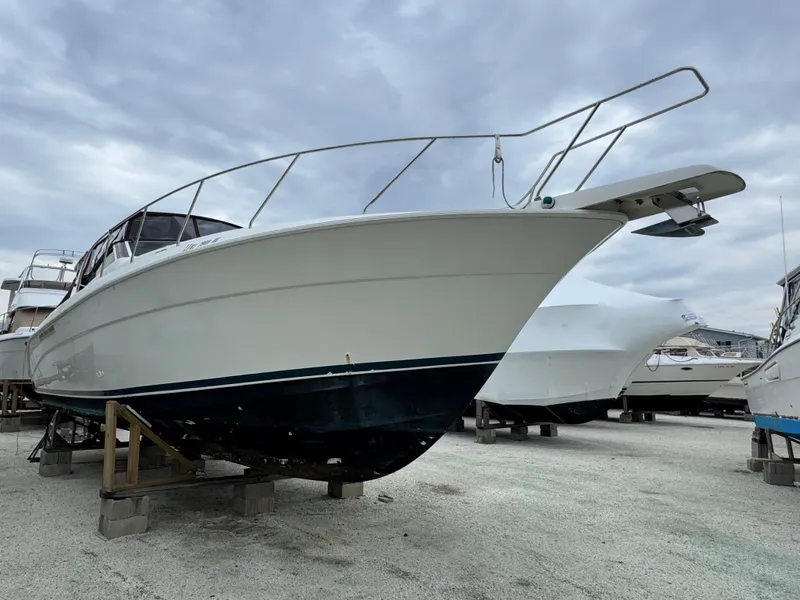 Slide: The Image of 1995 Silverton Express boat on dry dock under cloudy sky. - 3