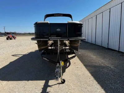 Slide: The Image of 2025 SunCatcher Select 322SS pontoon boat on trailer, parked outdoors. - 2