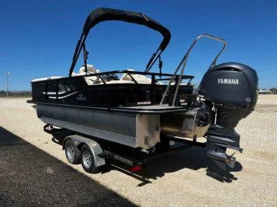 Slide: The Image of 2025 SunCatcher Select 322SS pontoon boat with Yamaha outboard motor on a trailer. - 4