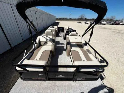 Slide: The Image of 2025 SunCatcher Select 322SS pontoon boat with spacious seating and canopy, parked outdoors. - 8