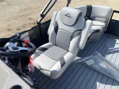 Slide: The Image of 2025 SunCatcher Select 320 RC boat interior with plush seating and steering wheel. - 7