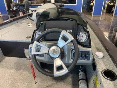 Slide: The Image of 2025 G3 Sportsman 1610 boat dashboard with steering wheel and control panel. - 5